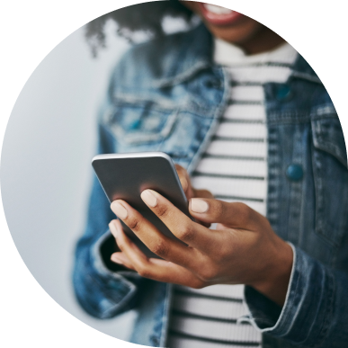 Woman holding her phone while smiling