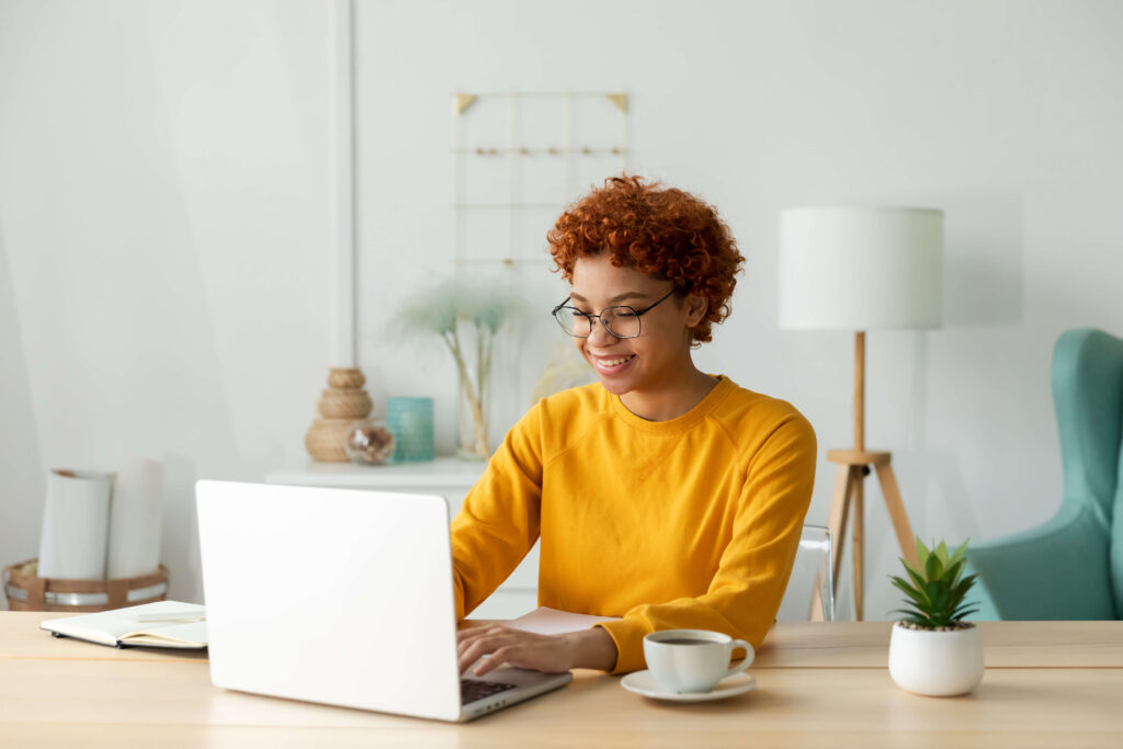 Woman sitting at desk typing on a computer