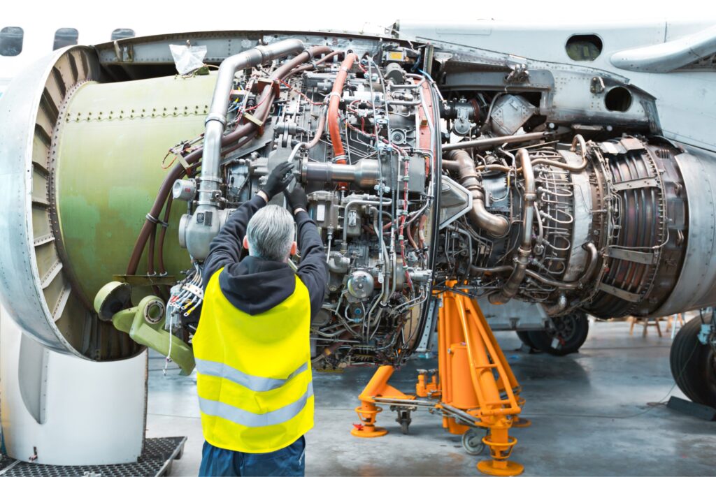 Duncan Aviation mechanic working on an airplane as part of workforce education and career upskilling program with AllCampus.